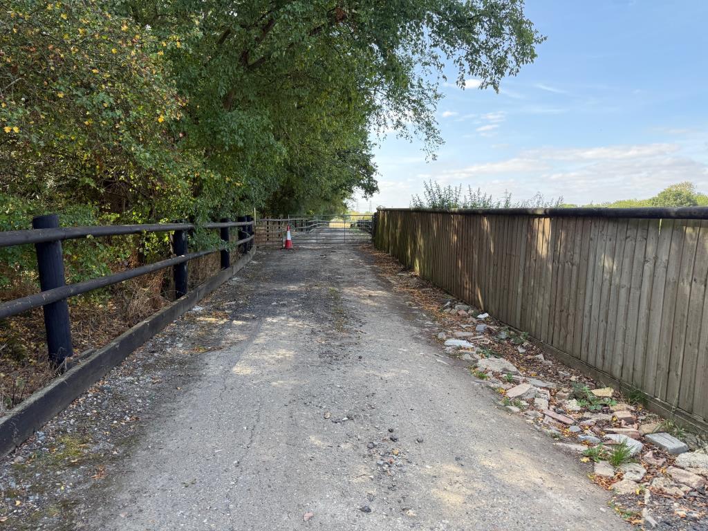 Lot: 72 - VACANT LAND IN VILLAGE LOCATION - Driveway and gates to access the land from Blind Lane